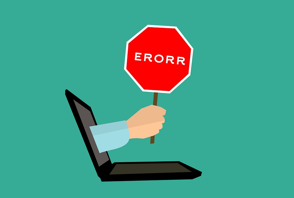 hand coming out of a laptop holding an error message sign- 404 redirection